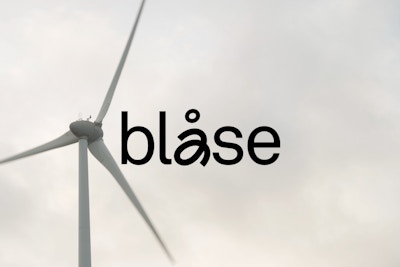 windmill in the background with logo animation on top